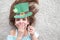 Closeup portrait of a happy preteen caucasian girl in an emerald leprechaun St. Patrick`s Day hat