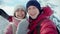 Closeup portrait of happy smiling young couple walking in snowy winter park at sunny winter day. man and woman lovely