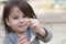 closeup portrait of little cute emotional girl with pigtails in a denim jacket