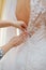 Closeup portrait of a maid of honor helping the bride with her dress