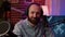 Closeup portrait of man recording online podcast with professional microphone smiling at camera