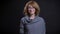 Closeup portrait of middle-aged extravagant redhead female in glasses smiling with excitement and happiness while