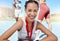 Closeup portrait of mixed race athletic woman with a medal from competing in sports event. Smiling fit active latino