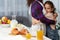 Closeup portrait of a mom embrace her cute daughter in the kitchen near table, take breakfast together.