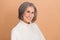 Closeup portrait of optimistic charming old woman gray hair cheerful smile wear white knitted sweater fresh skin