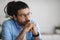 Closeup Portrait Of Pensive Millennial Indian Man In Eyeglasses Looking Away