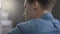 Closeup portrait of pensive young man in blue shirt, indoors.