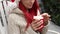 Closeup portrait of pretty woman in santa hat drinks cocoa with marshmallows