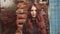 Closeup portrait of a redheaded girl with a mysterious look. girl with freckles looks at camera