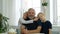 Closeup portrait of a senior beared man hugging his grandsons. Happy family concept
