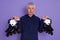 Closeup portrait of senior man being ready to roller skating outdoors. Elderly man enjoying sports, active old age, white haired