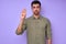 closeup portrait of serious man showing hello hi sign in deaf language