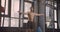 Closeup portrait of shirtless muscular handsome caucasian man doing leg raises on the bars looking at camera smiling