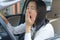 Closeup portrait sleepy, yawn, close eyes young woman driving he