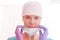 Closeup portrait of smiling doctor wearing surgical cap removing mask at clinic