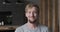 Closeup portrait of smiling European blonde guy posing at luxury apartment loft interior