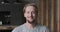 Closeup portrait of smiling European blonde guy posing at luxury apartment loft interior