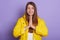 Closeup portrait of smiling female with palms together, standing and praying, lady looks hopeful, winsome woman poses smiling