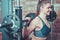 Closeup portrait smilling athletic woman exercising with barbell at smith machine.