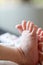 A closeup portrait of some baby feet. The newborn child is stretching its little cute toes to the limit