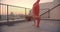 Closeup portrait of spiritual caucasian female with dreadlocks doing yoga on rooftop with beautiful sunset on background