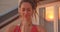 Closeup portrait of spiritual female with dreadlocks practicing yoga smiling happily on rooftop with beautiful city