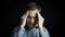 Closeup portrait of stressed man with headache, isolated on black background