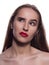 Closeup portrait of suspicious brunette girl with bright makeup, posing on a white background