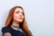 Closeup portrait of a thoughtful redhead woman