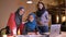 Closeup portrait of three beautiful successful arabian female office workers looking at camera and smiling cheerfully on