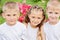 Closeup portrait of three children with flowers at