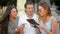 Closeup Portrait of Three Students Talking and Studing Together Outdoors Sitting on the Bench. Group of Young People