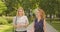 Closeup portrait of two female friends walking having conversation smiling cheerfully in park outdoors