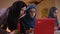 Closeup portrait of two young muslim female employees discussing the topic using the laptop. Group of three islamic