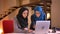 Closeup portrait of two young muslim female office workers in the hijabs in the office in front of the laptop. Teamwork