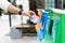 Closeup portrait woman hand throwing crumpled paper in recycling bin