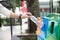 Closeup portrait woman hand throwing empty plastic water bottle in recycling bin