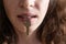 Closeup portrait of woman silent with key in her mouth. Women& x27;s secrets. Silence is golden