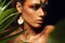 Closeup portrait of woman tanned skin colored makeup tropical jungle paint on the face sweat plant palm leaves wild style exotic