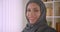 Closeup portrait of young attractive successful muslim businesswoman in hijab looking at camera smiling cheerfully in