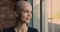 Closeup portrait of young bald optimistic female cancer patient