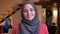 Closeup portrait of young beautiful arabian female office worker looking straight at camera with cheerful smile being on