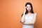 Closeup portrait of a young beautiful brunette pensive woman holding her hand new her head and looking down, think about something