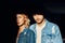 Closeup portrait of young and beautiful couple wearing denim jeans