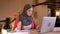 Closeup portrait of young beautiful muslim businesswoman in hijab working in intercultural community using the laptop