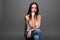 Closeup portrait of young beautiful woman with with beautiful long hair. Sitting and posing in studio. Portrait of trendy, cheerfu