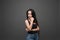 Closeup portrait of young beautiful woman with with beautiful long hair. Sitting and posing in studio. Portrait of trendy, cheerfu