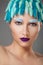 Closeup portrait of young beautiful woman with blue hair and eyebrows