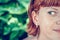 Closeup portrait of young beautiful woman on green leafs back. Tropical lady scene. Bali island.