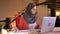 Closeup portrait of young busy muslim office worker in hijab examining the data on the diagrams and graphs in front of